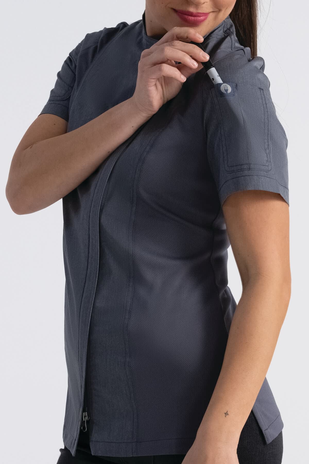 A women's chef jacket in grey, featuring a zip front and short sleeves, with a pocket detail on the sleeve.