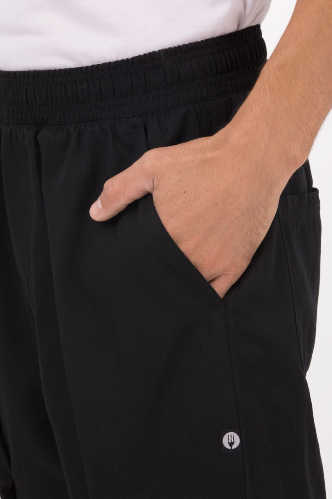 Black men's baggy chef pants featuring an elastic waistband and a side pocket. Includes a small logo.