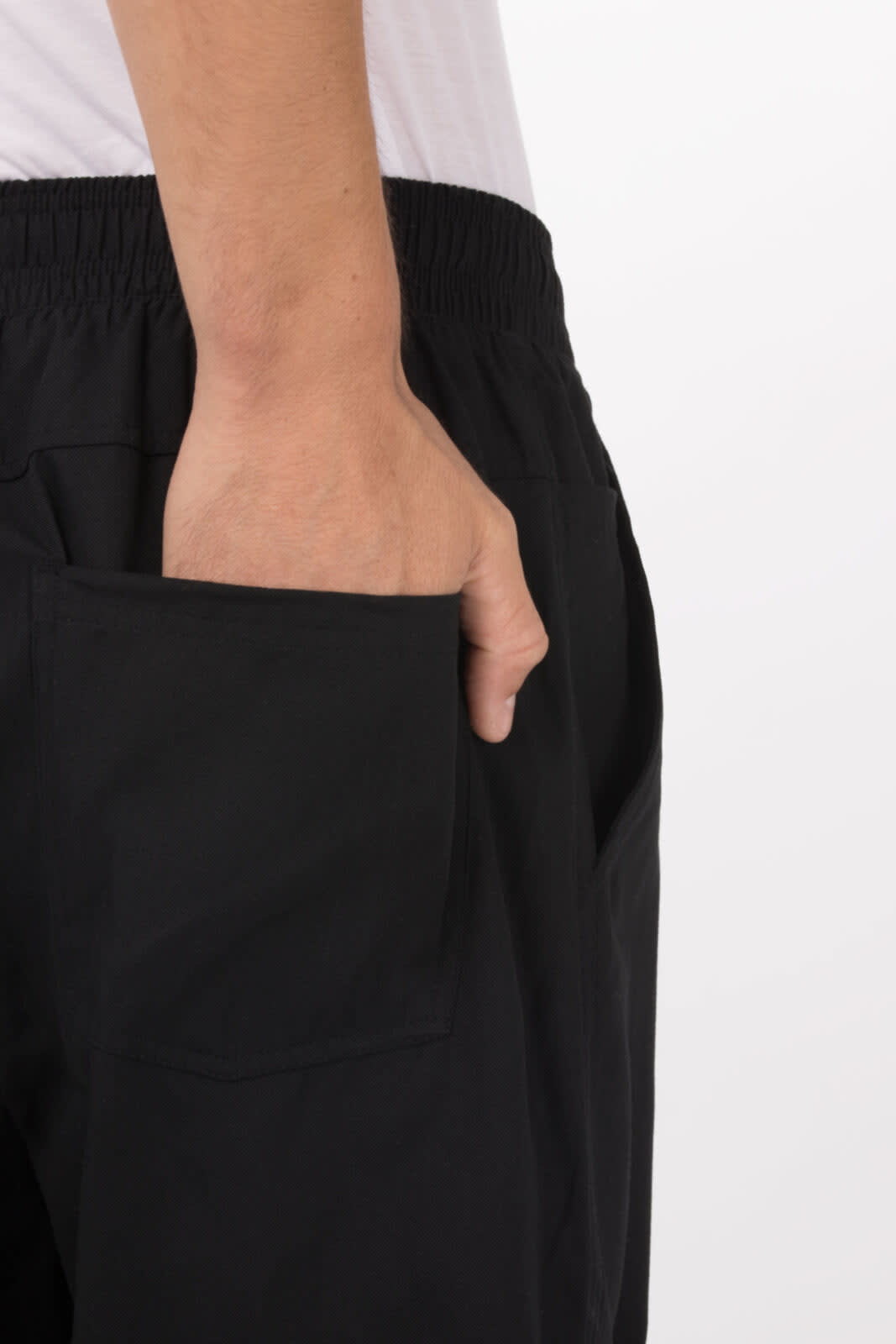 Black baggy chef pants with an elastic waistband and a side pocket visible on the hip.