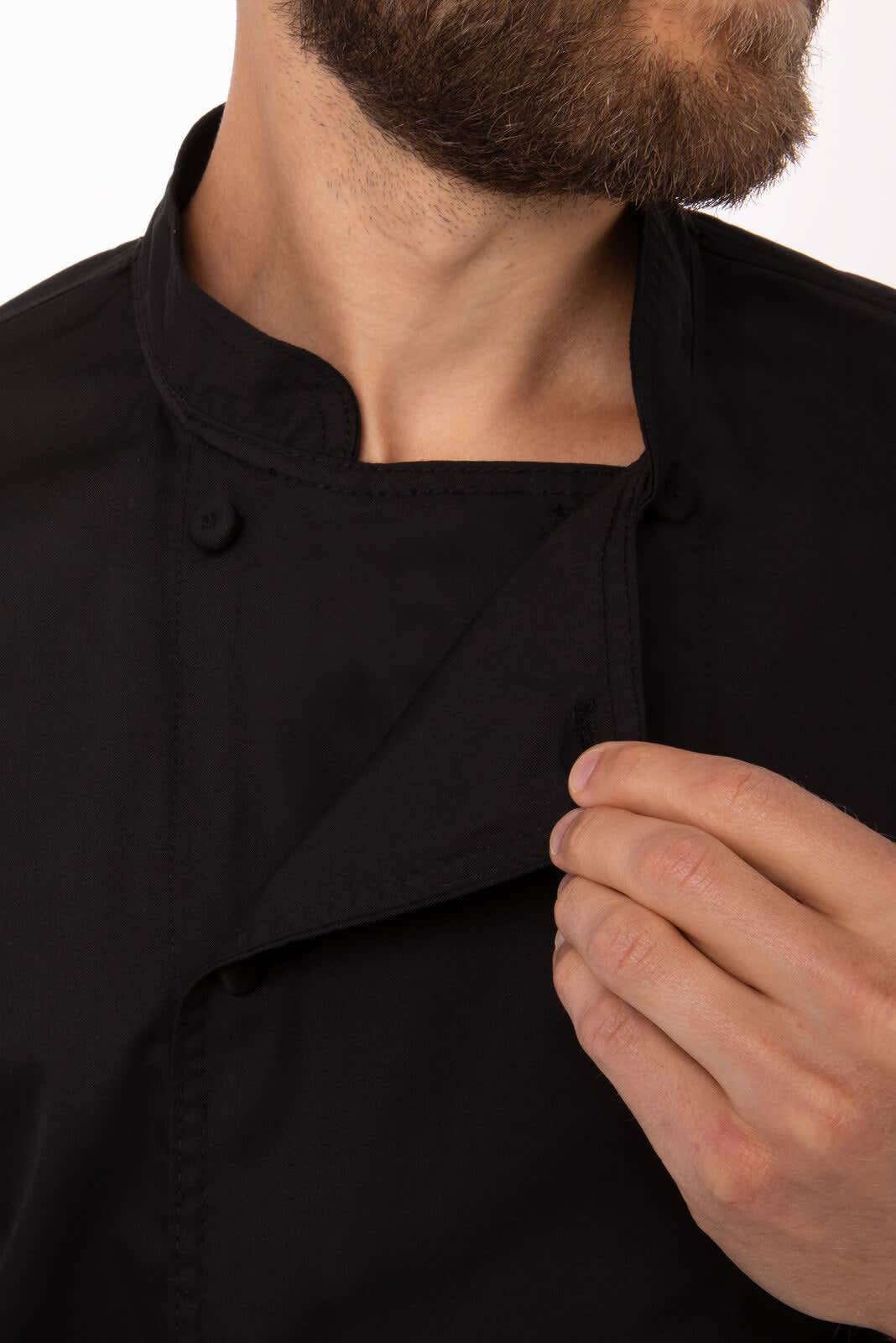 A black chef jacket with a stand collar, featuring buttons and a person adjusting the collar.