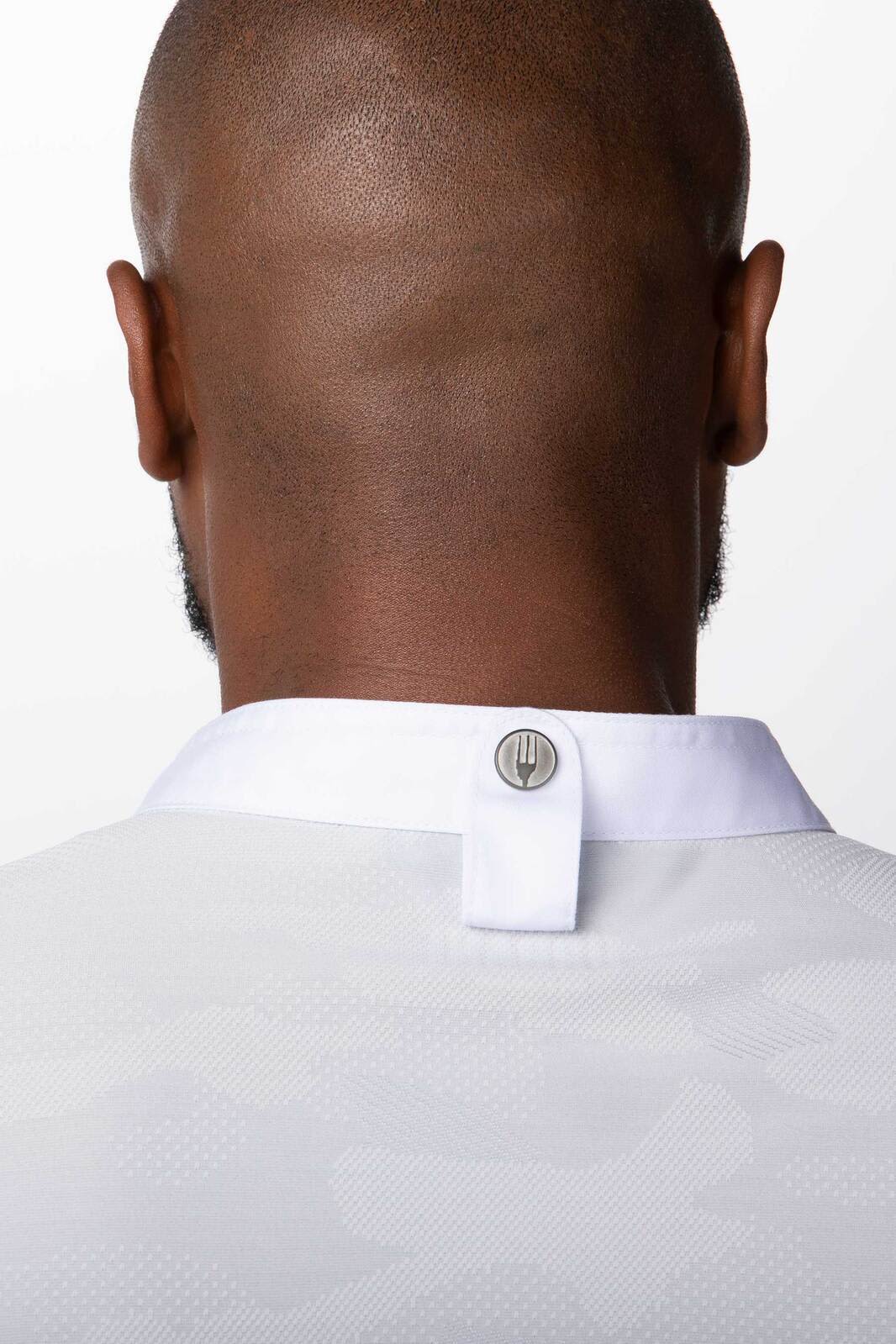 A men's chef jacket in green displayed from the back, showing the collar and a button detail.