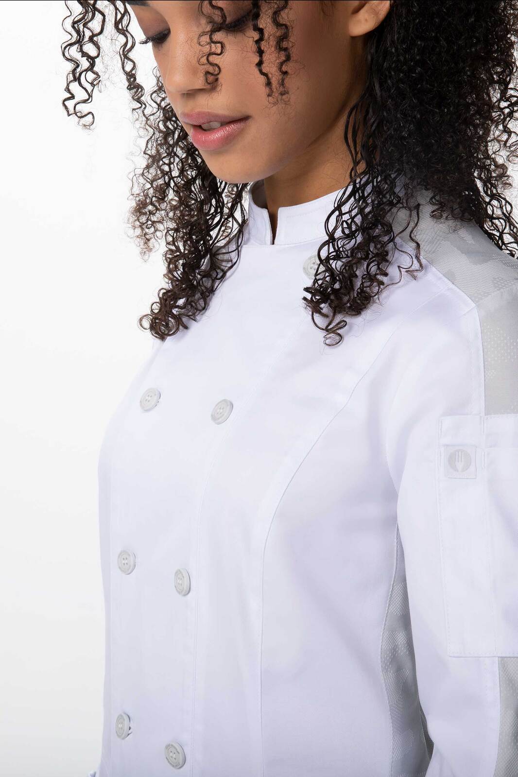 A white women's chef jacket featuring a stylish design and a branded logo on the sleeve.