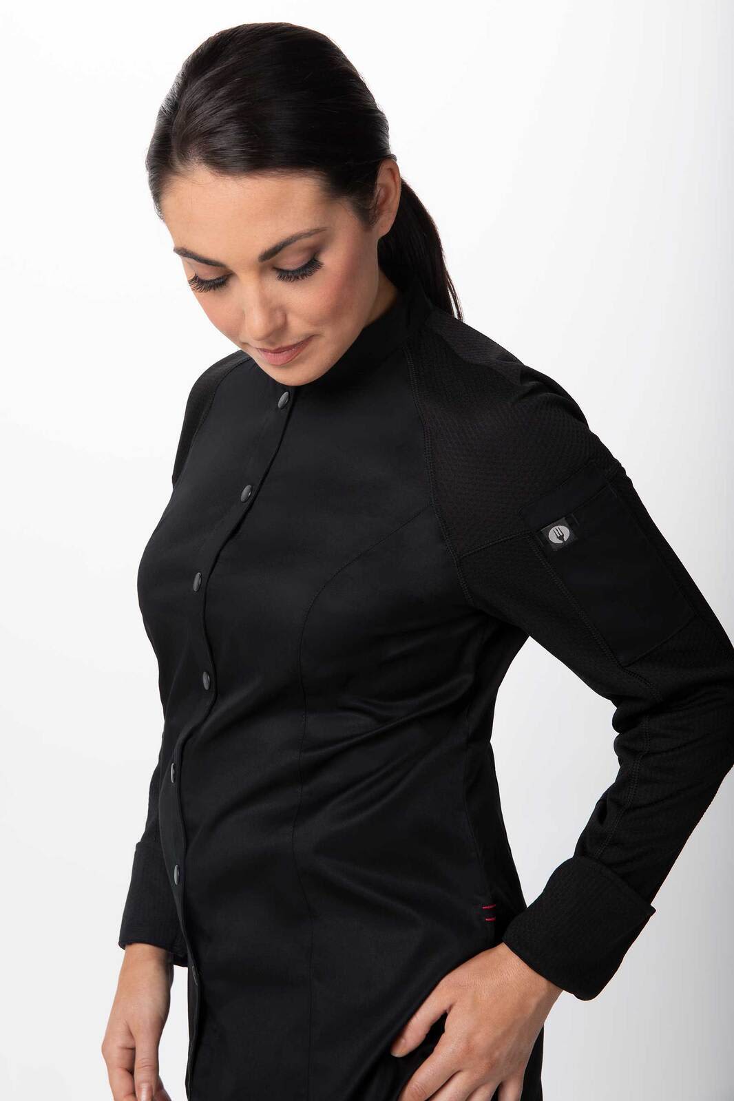 A black women's chef jacket featuring a fitted design and a logo on the sleeve.