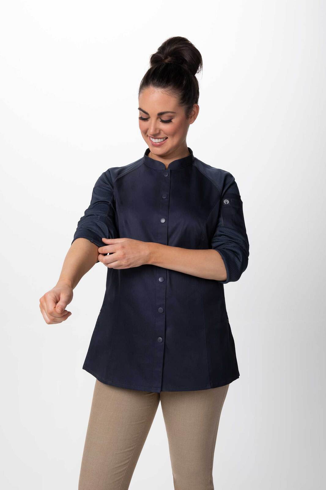 A women's chef jacket in navy, featuring a button-up front and long sleeves, with a logo on the sleeve.
