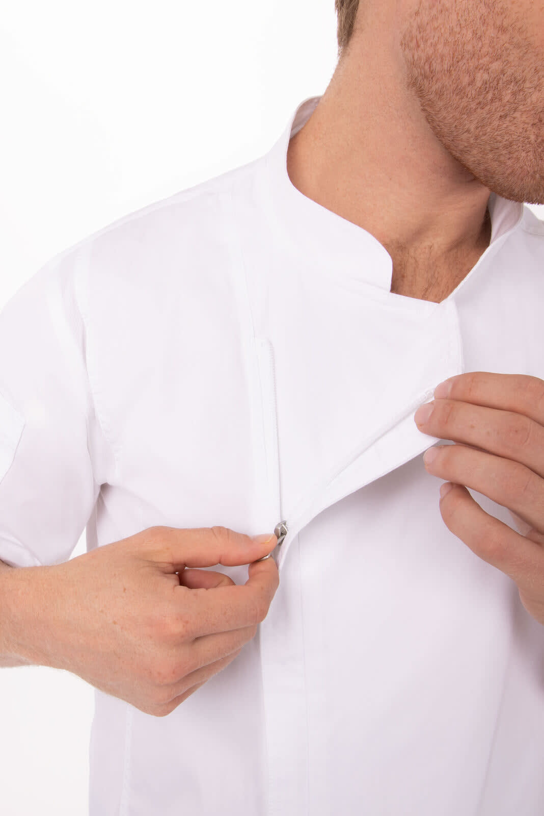 A white chef jacket with a zippered front, being partially unfastened by a person. The jacket has a sleek design and a branding logo.