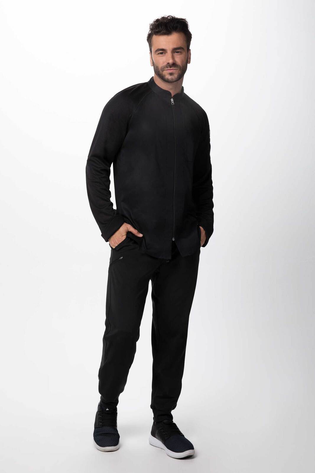 A black men's chef jacket features a zip front and is styled with matching black trousers and shoes.