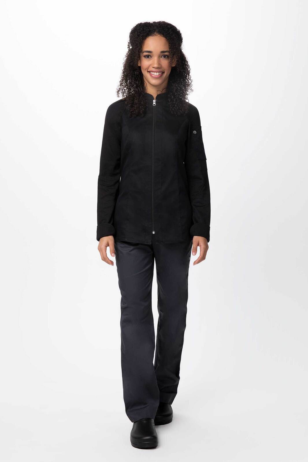 A black women's chef jacket with long sleeves and a zip-front, paired with dark trousers.