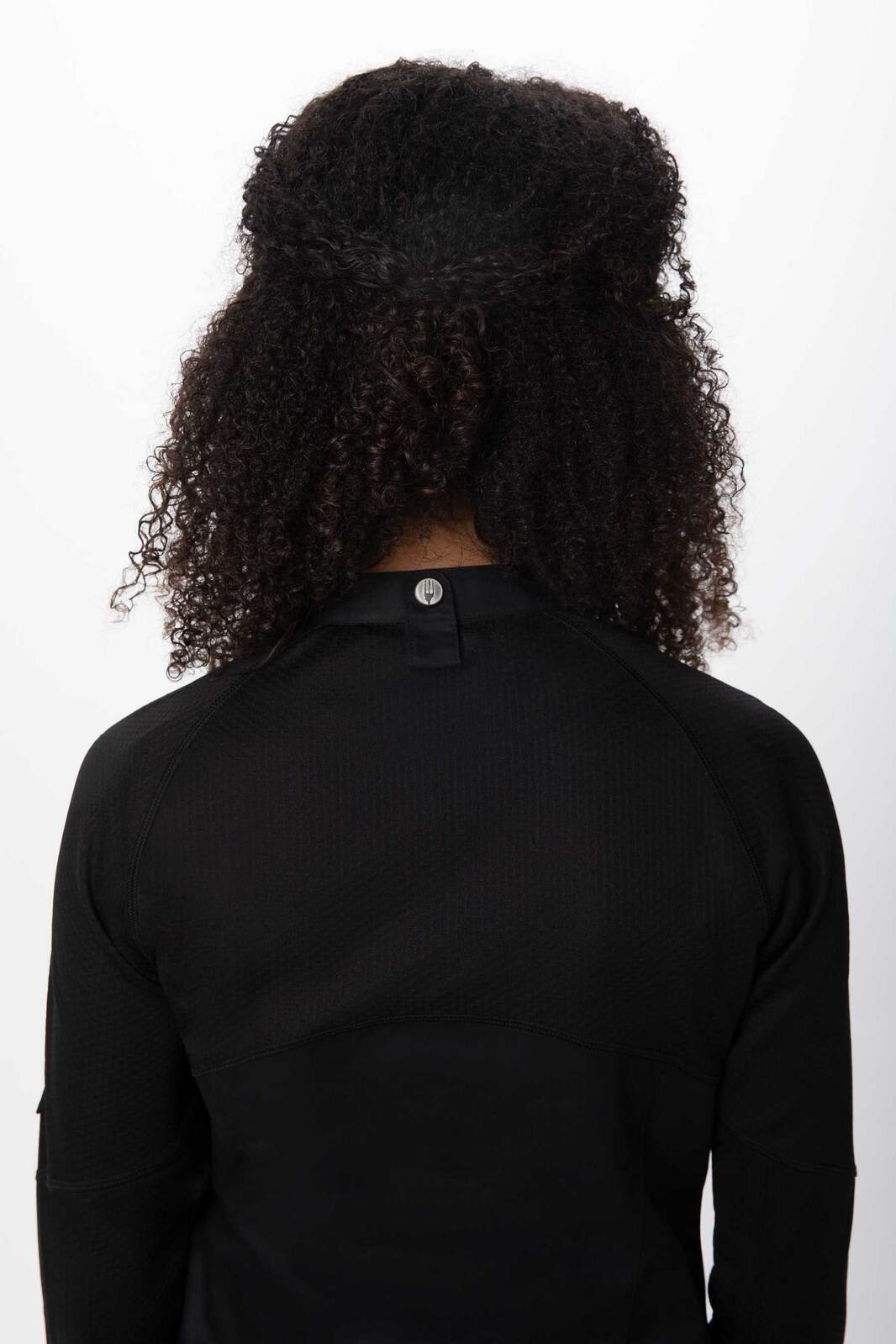 A black women's chef jacket featuring a back view with a button detail and a stylish fit.