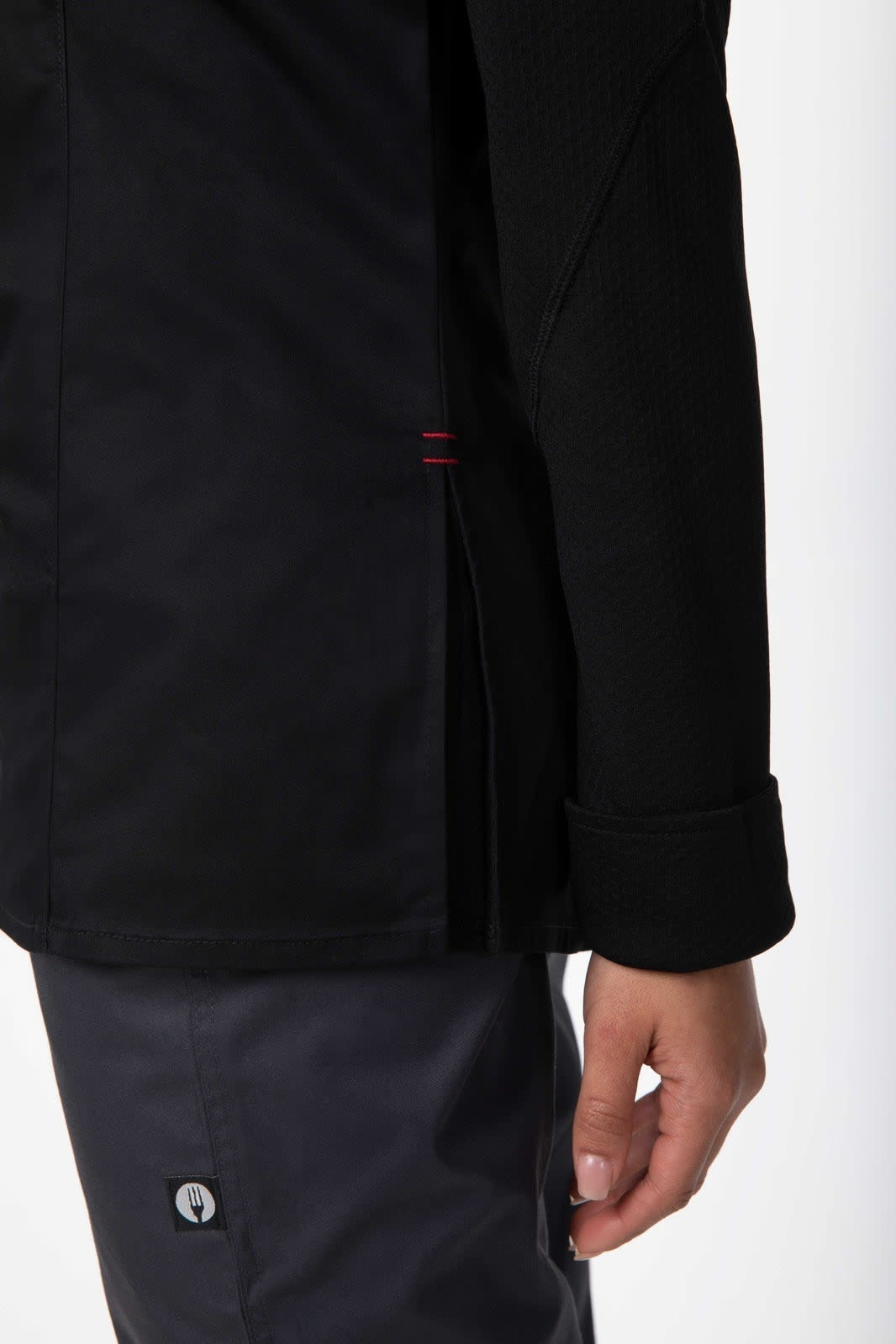 A black women's chef jacket featuring a side slit and tailored fit, designed for comfort and style in the kitchen.