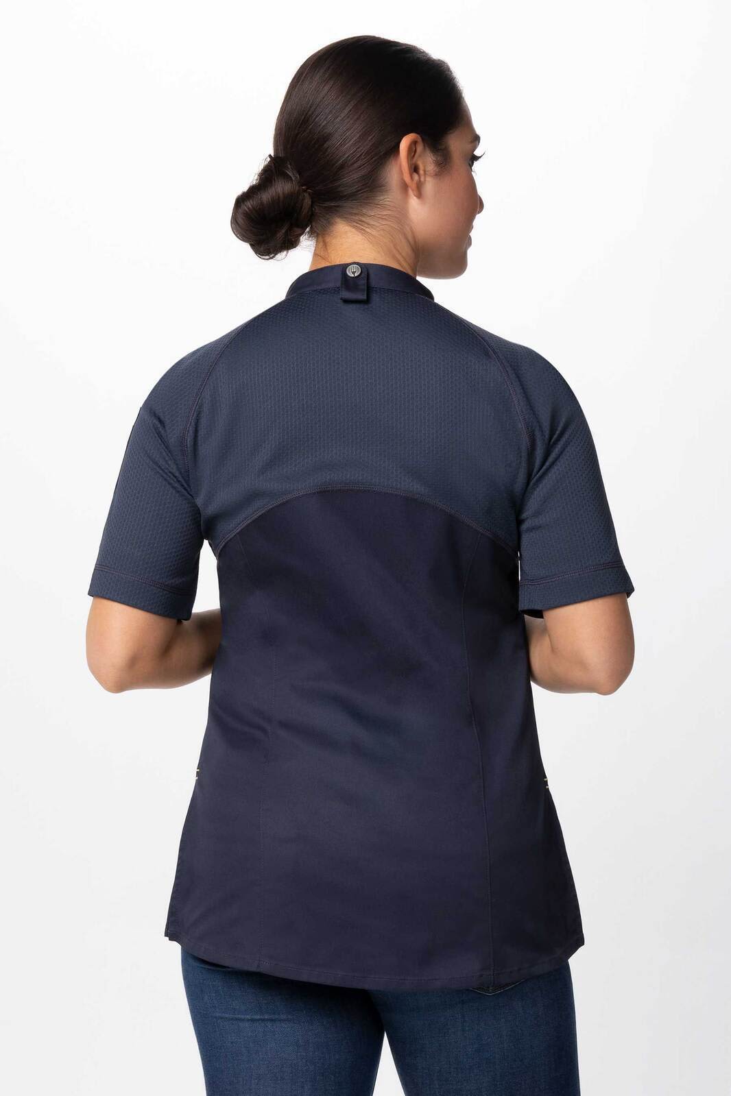 A women's chef jacket in navy blue with a short sleeve design and back detailing, featuring a logo.