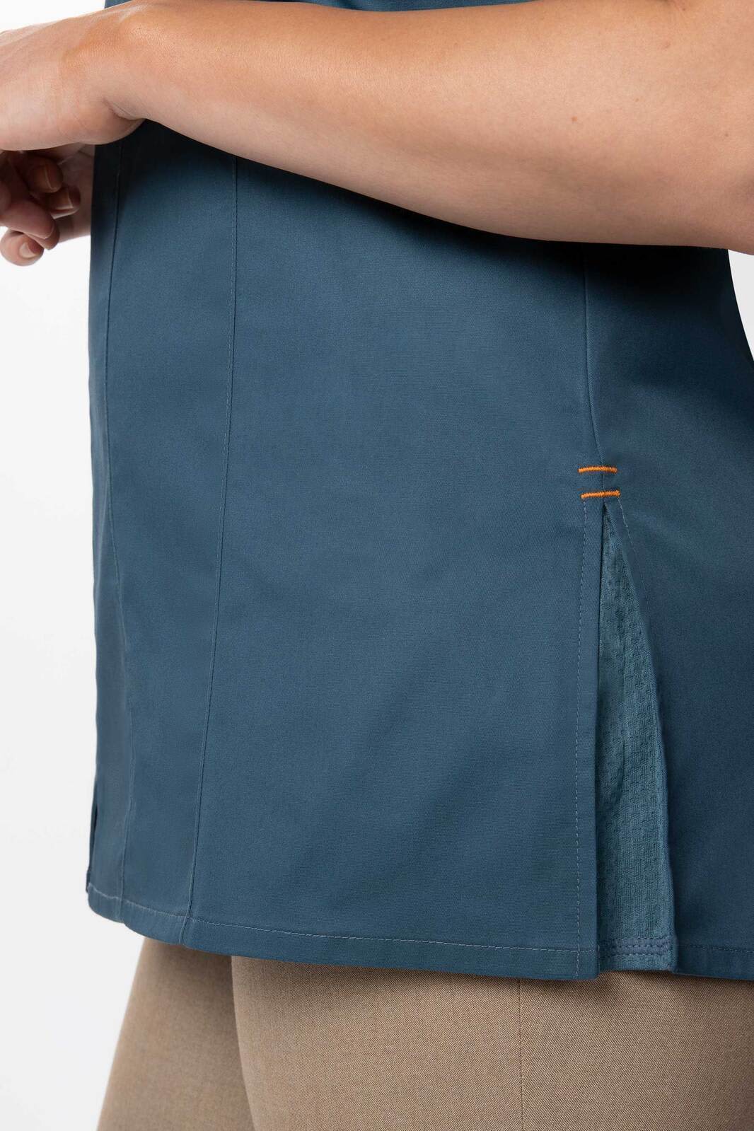 A women's chef jacket in teal with side slits and contrast detailing, featuring a logo.