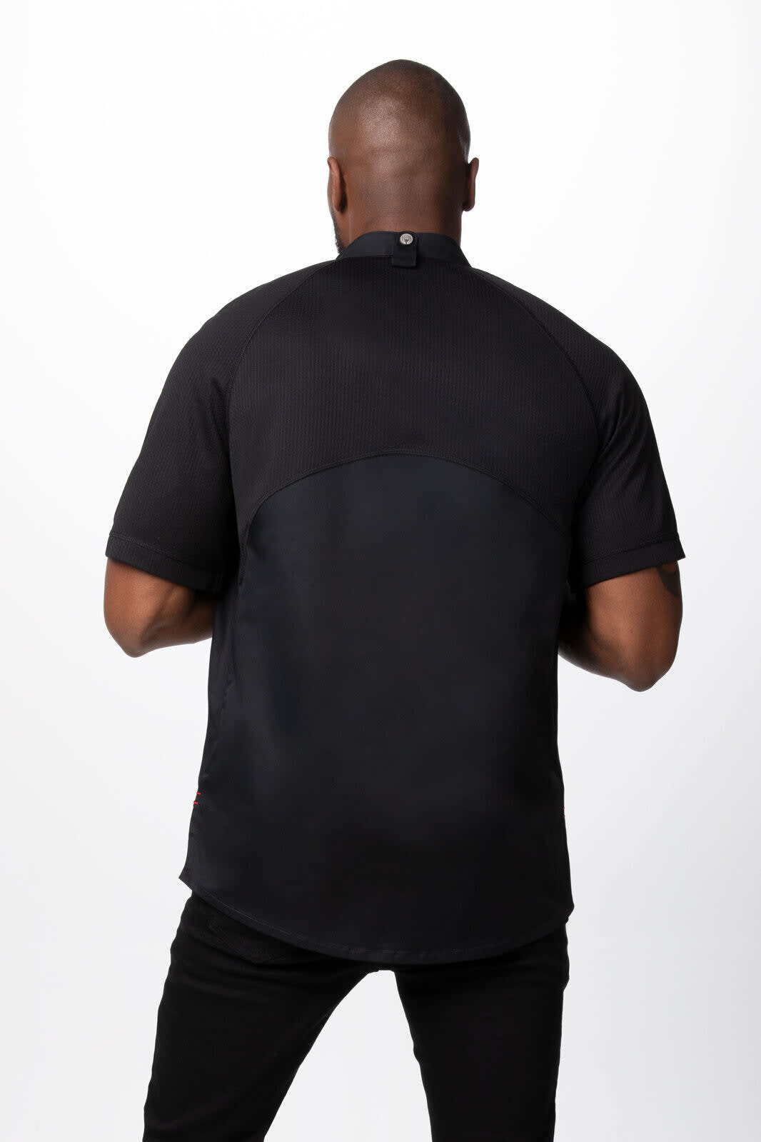 A men's chef jacket in black, featuring short sleeves and a back button detail, viewed from the rear.