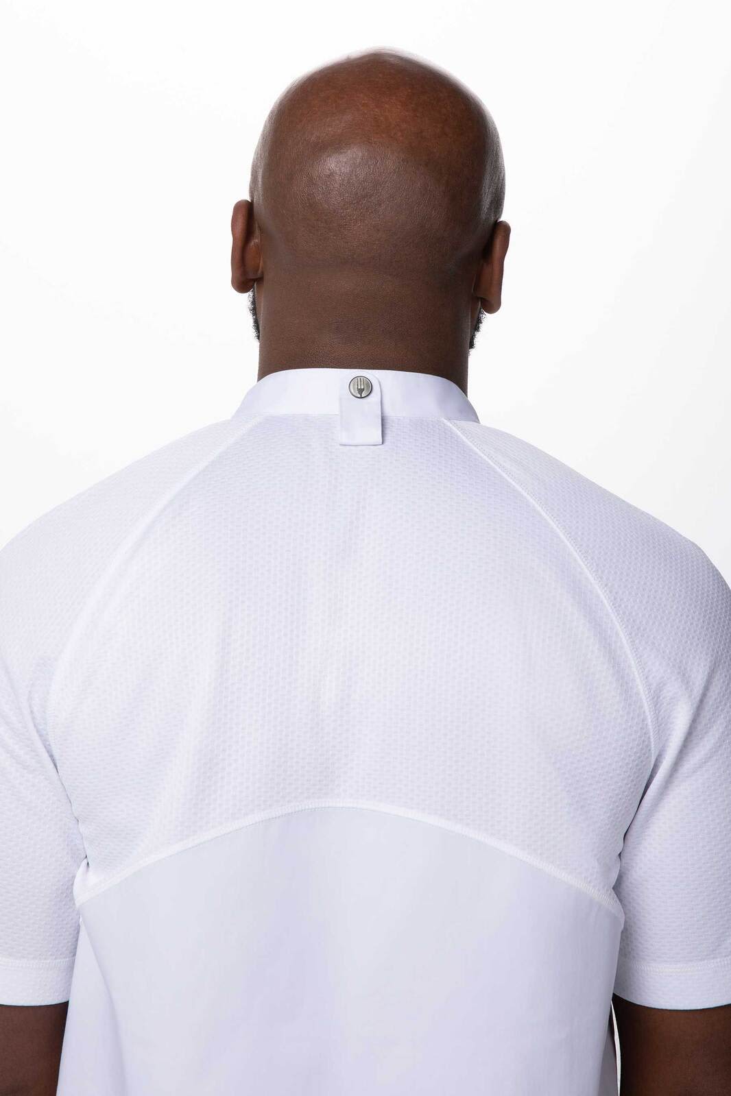 A white chef jacket featuring a high collar and a back button detail, designed for men. It includes a branding logo.