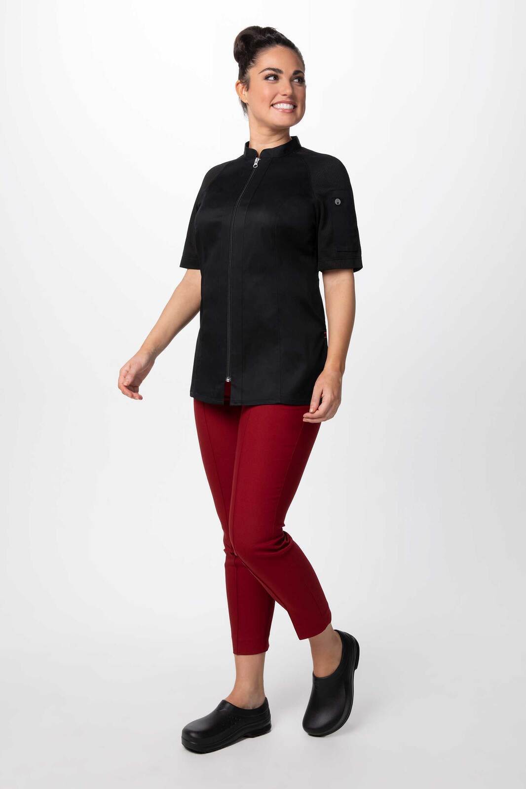 A black women's chef jacket with a zip-front design, paired with red pants and black shoes.