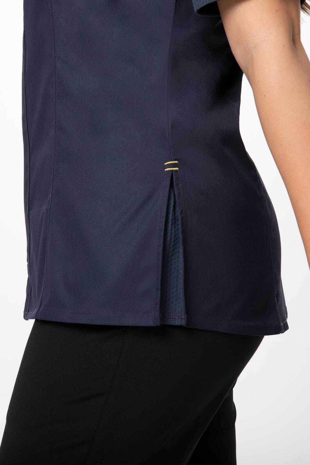 A navy blue women's chef jacket featuring a side vent for added style and comfort, with a subtle logo.