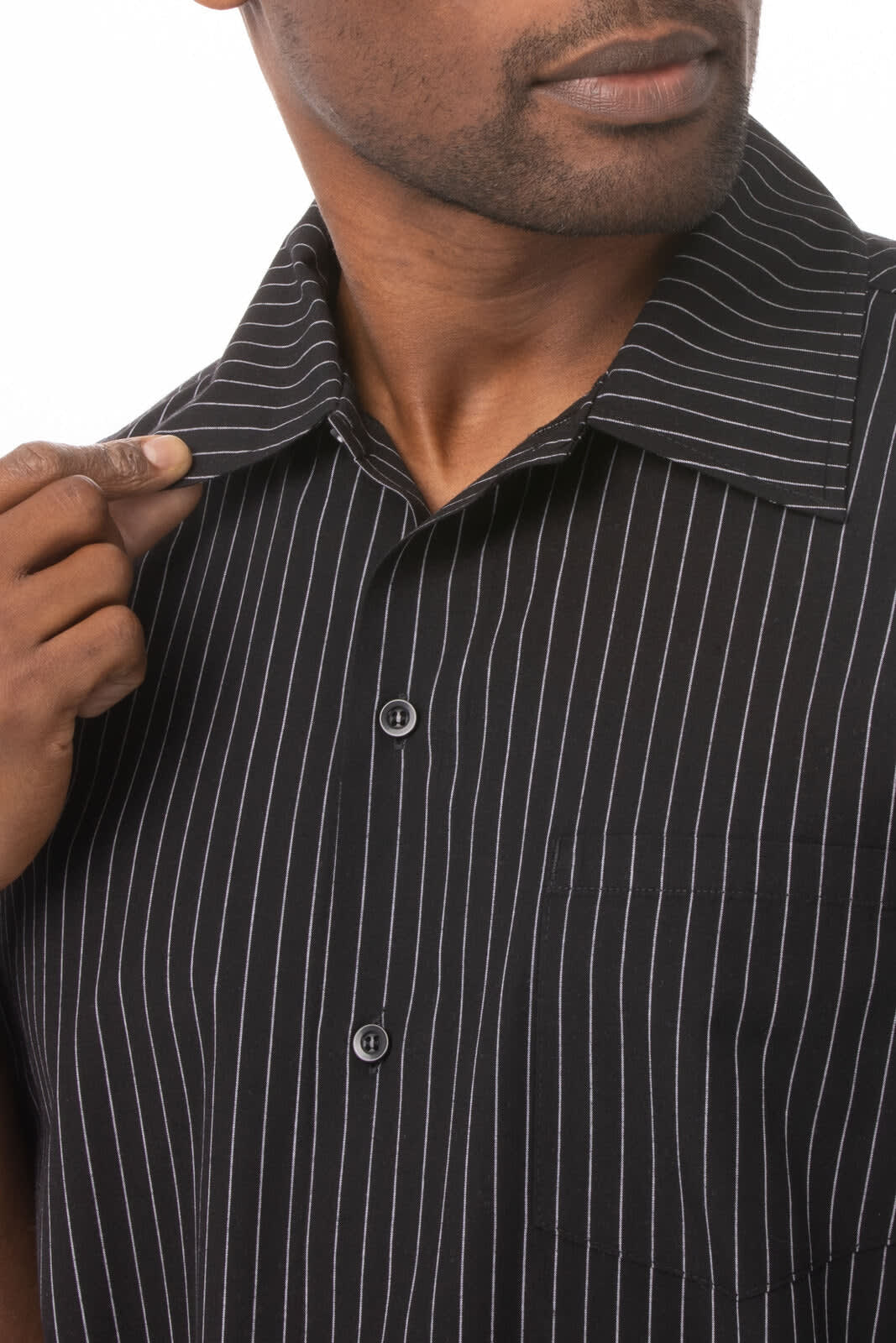A black chef shirt with white pinstripes, featuring a collar and button-down front. It has a logo on the chest pocket.