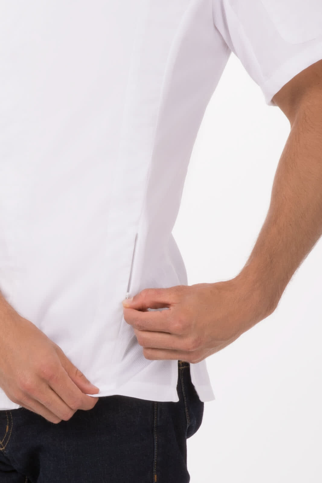 A white chef jacket with a side vent being adjusted, featuring a logo on the chest area.