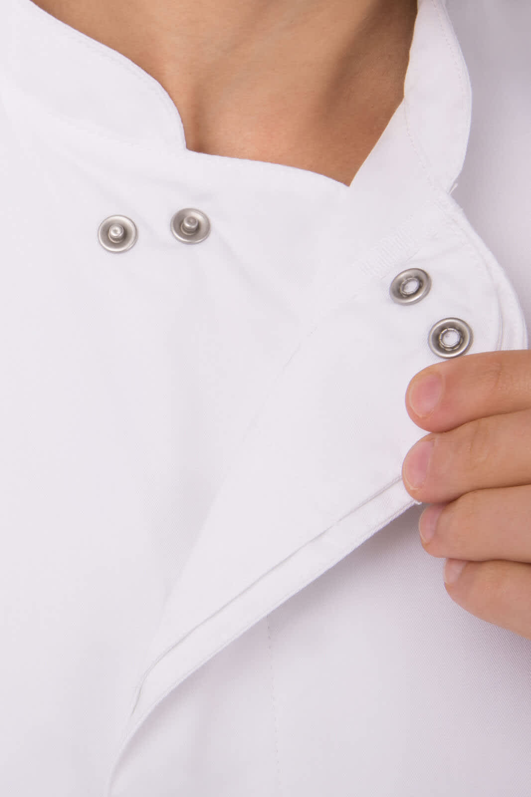 A white chef jacket featuring a snap closure and a folded collar. The fabric appears smooth and professional.