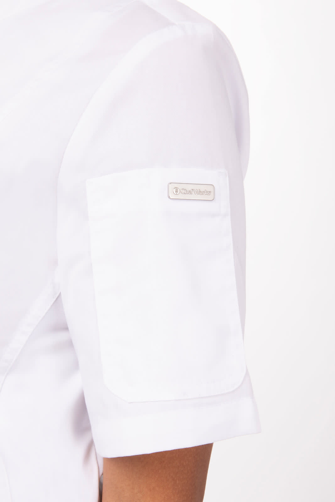 A white women's chef jacket featuring a short sleeve with a pocket and a logo on the arm.