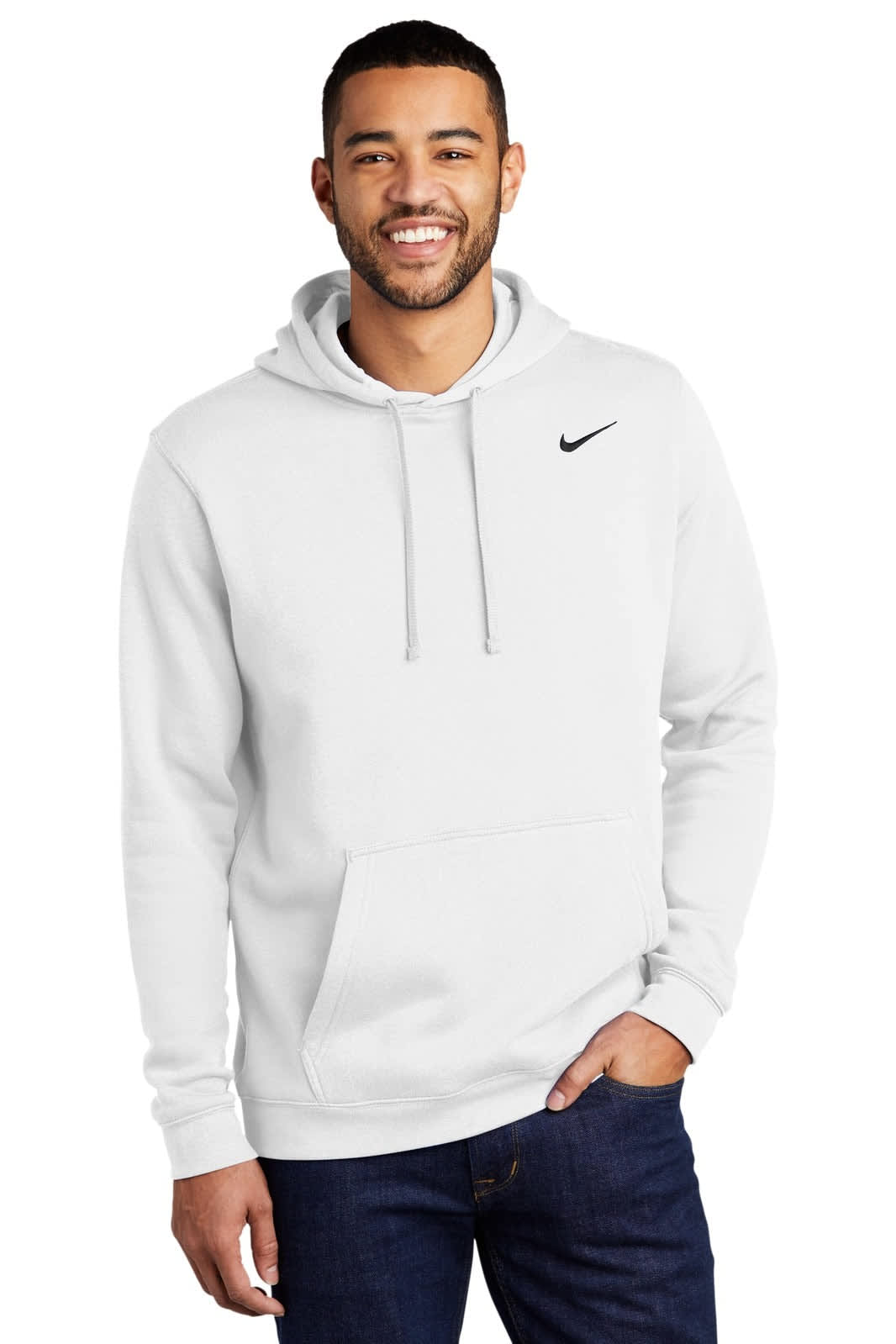 A white Nike Club Fleece pullover hoodie with a front pocket and a logo on the chest, worn by a smiling male model.