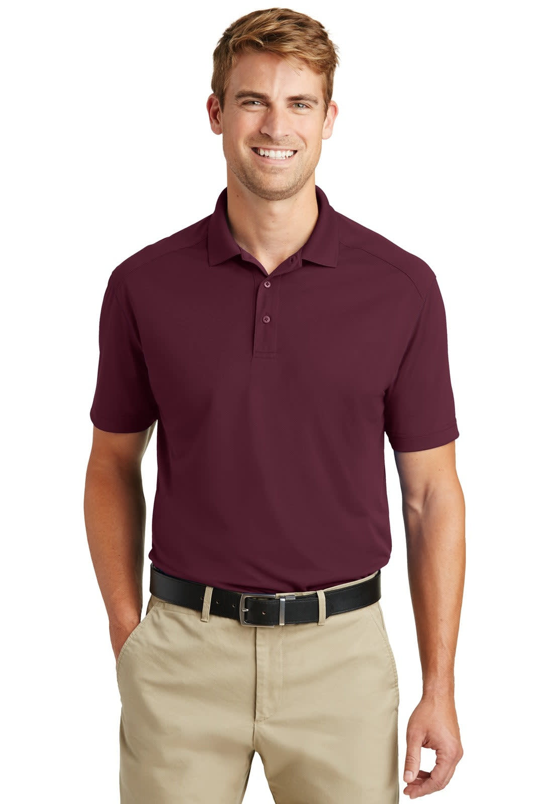 A maroon polo shirt with a collar, featuring a logo, worn by a smiling man with tan trousers and a black belt.
