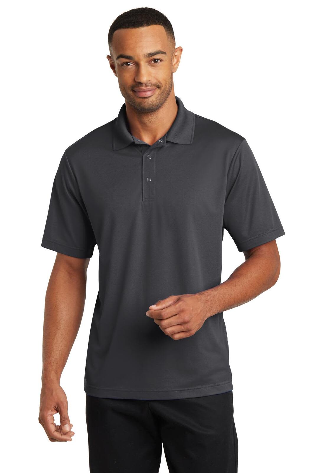 A man is wearing a dark grey polo shirt with a logo on the chest, featuring a classic collar and short sleeves.
