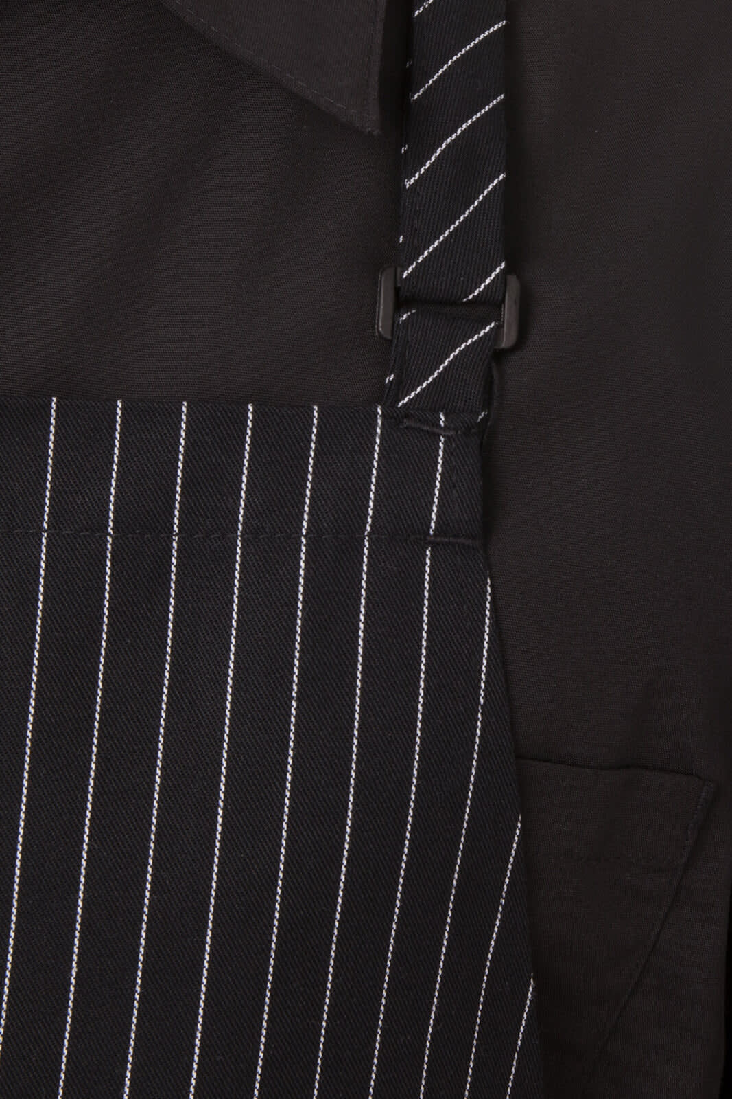An adjustable black bib apron with white stripes, featuring a buckle for size adjustment. It has a front pocket and a logo.