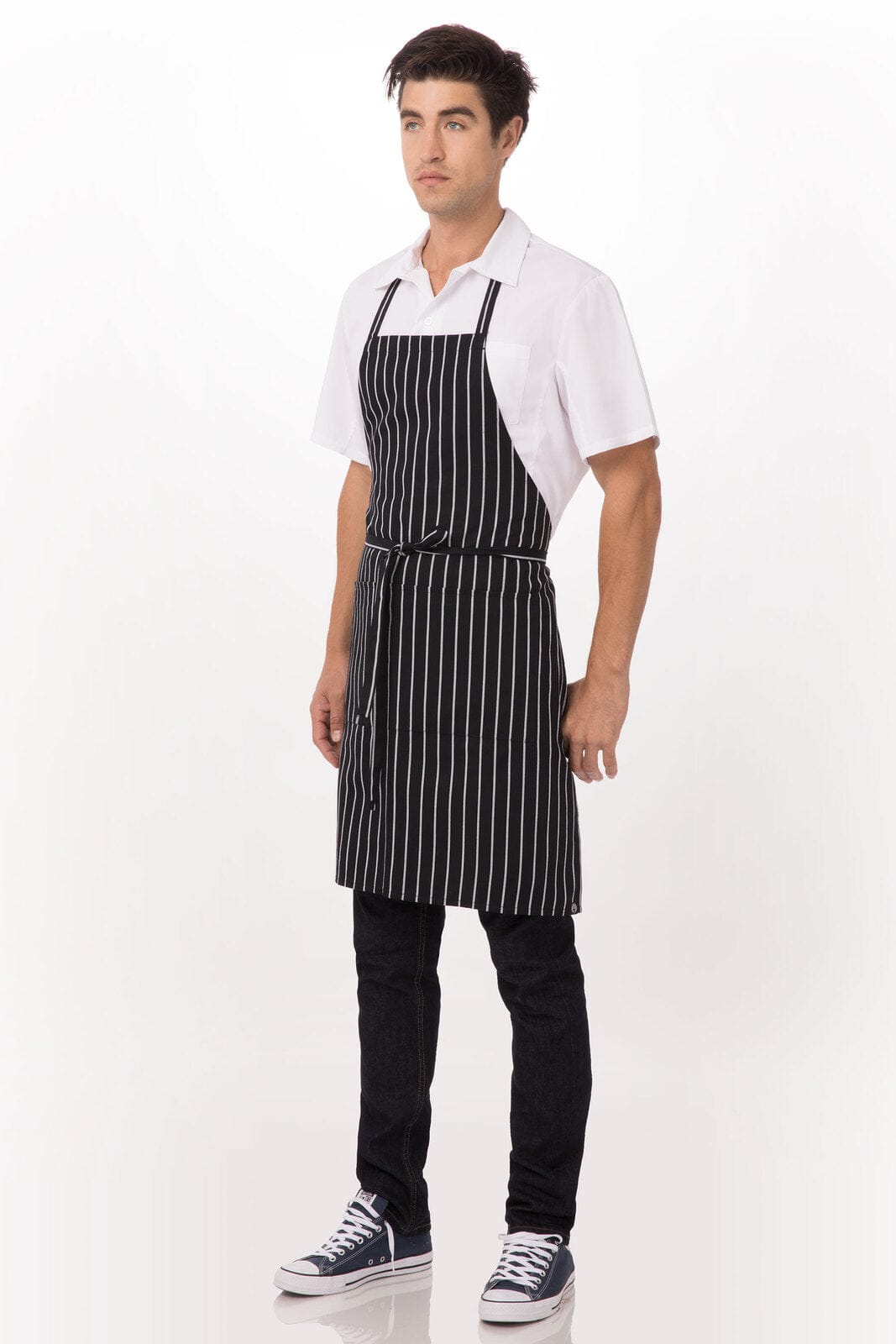 A black and white striped bib apron worn over a white shirt and dark pants, featuring an adjustable neck strap.