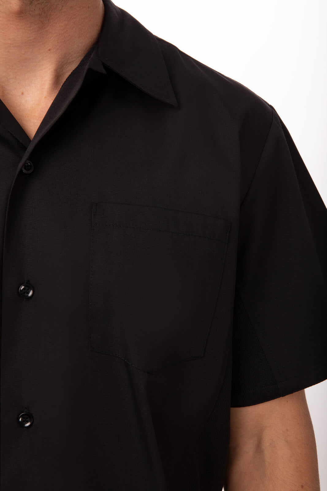 A black short-sleeved cook shirt with a pocket on the left chest and a button-up front. It features a branding logo.