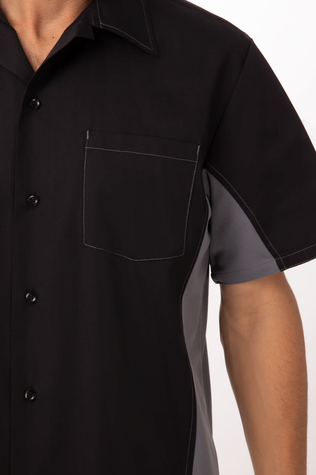 A black and grey men's shirt with a pocket and a logo. It features contrasting stitching and buttons.