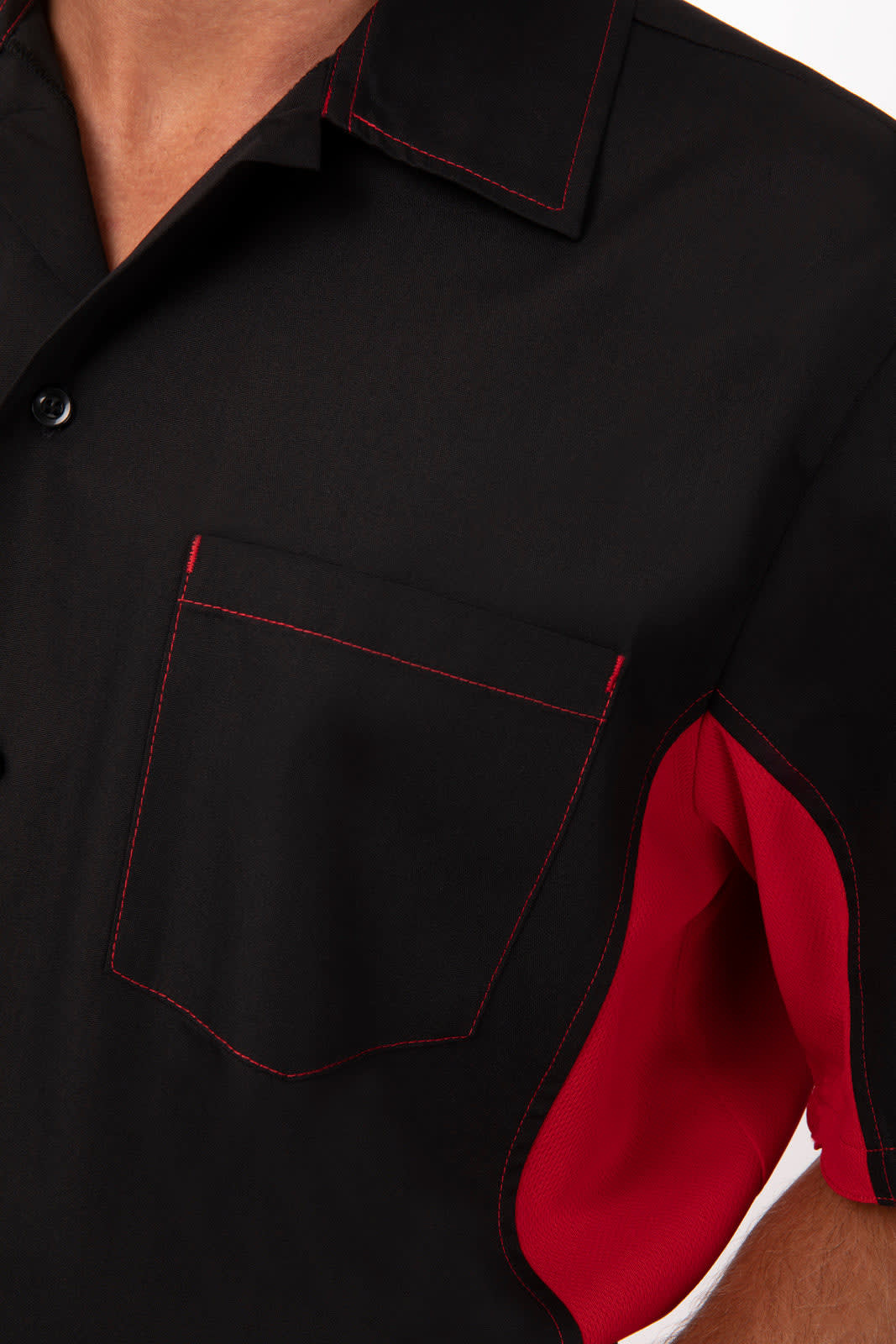 A men's shirt in black with red accents and stitching, featuring a chest pocket and a logo.