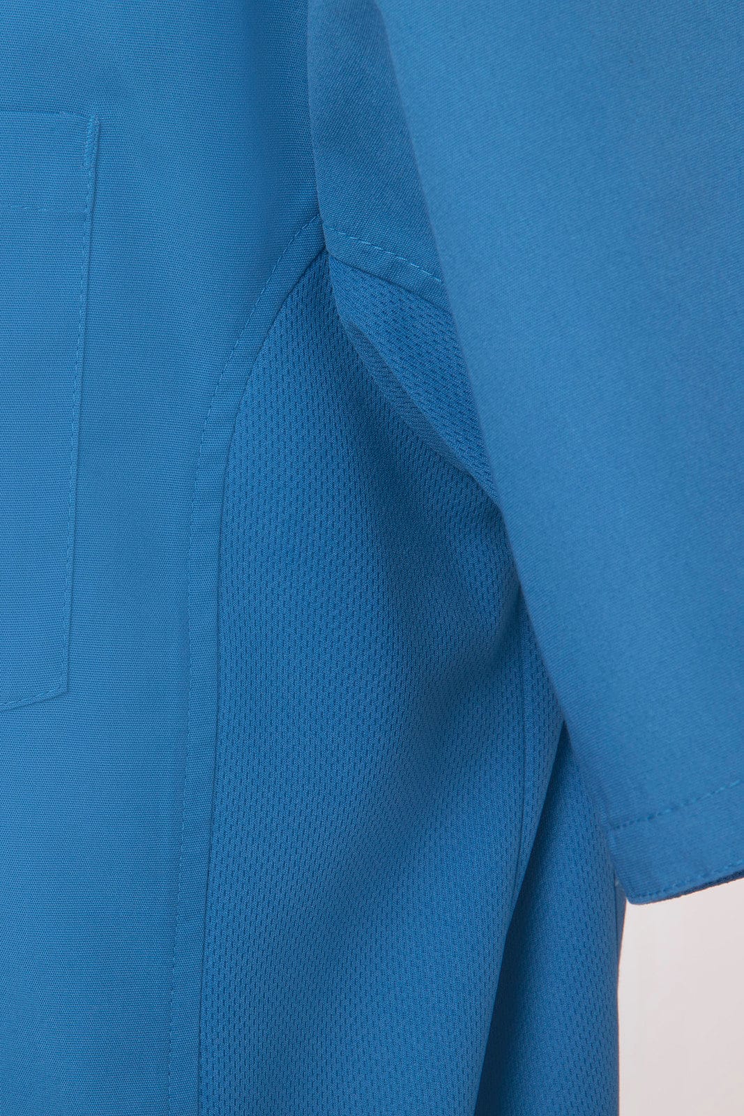 A blue universal men's shirt displaying short sleeves and a mesh panel texture. Features a branding logo.