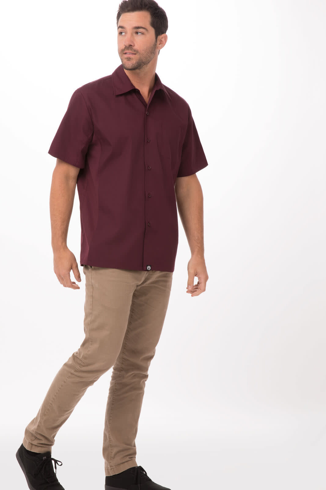 A maroon short-sleeved men's shirt with a collar, worn with beige trousers and black shoes. The shirt features a logo.
