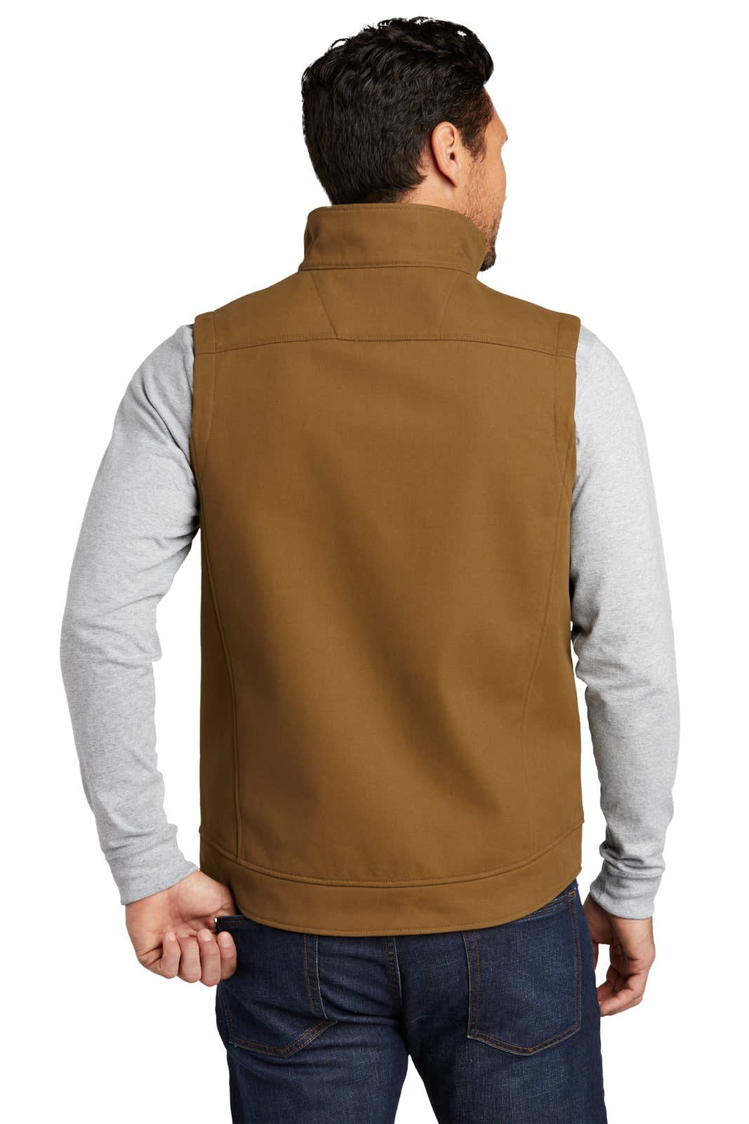 A back view of a brown soft shell vest worn over a long-sleeve grey shirt, featuring a logo on the left side.