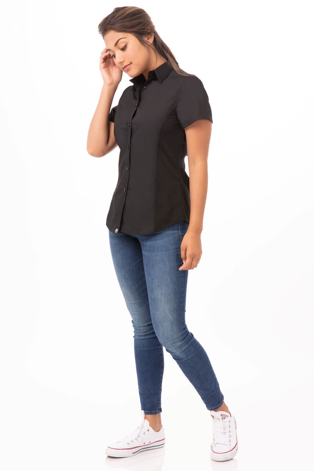 A black women's shirt with short sleeves, paired with blue jeans and white sneakers, featuring a logo.