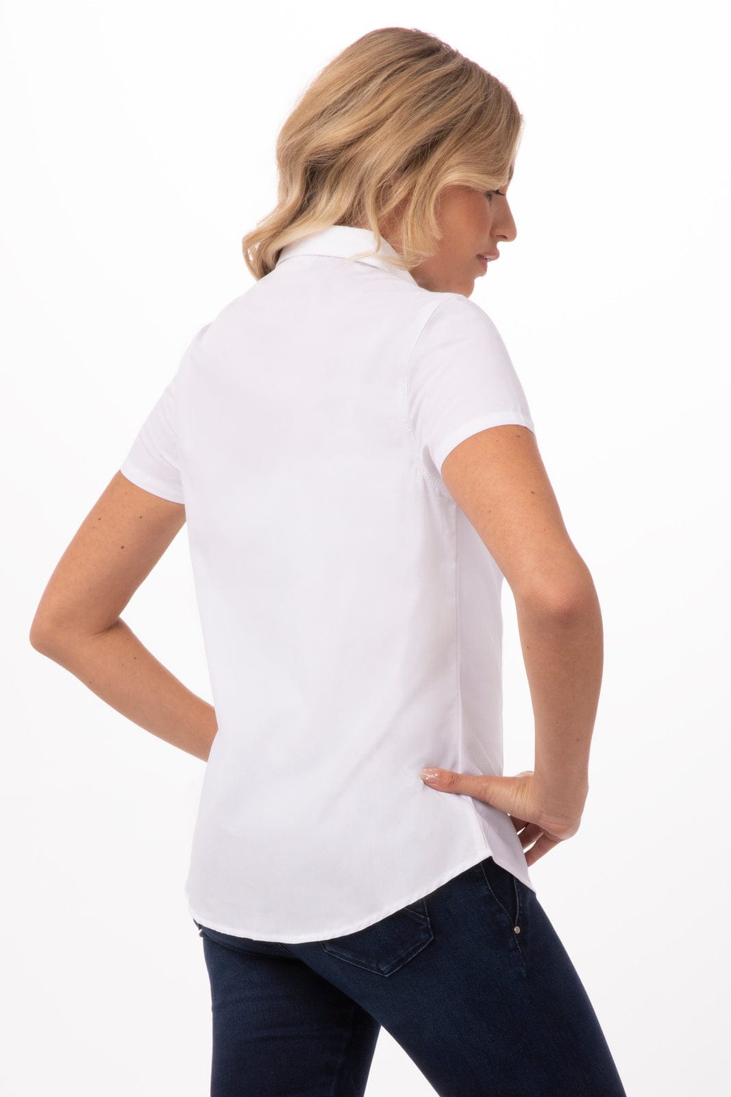 A white short-sleeve women's shirt displayed on a model, showing the back view. The shirt has a collar and a logo.