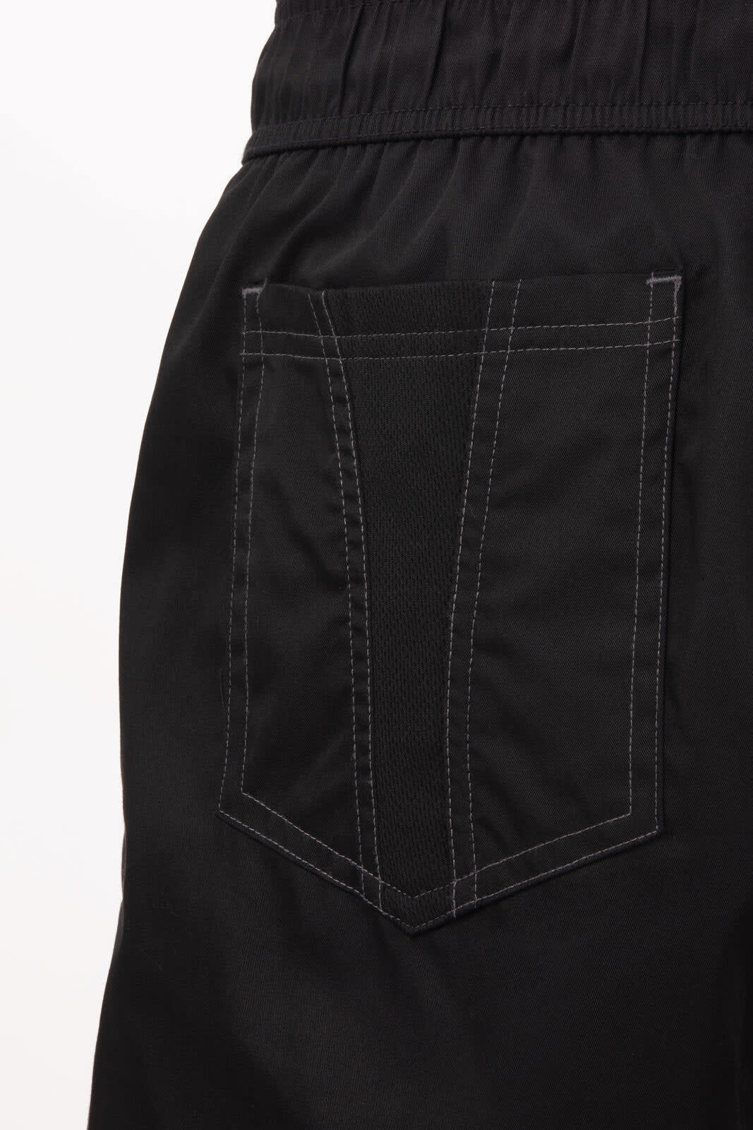 A close-up of black chef pants featuring a back pocket with visible stitching. The fabric appears lightweight and breathable.