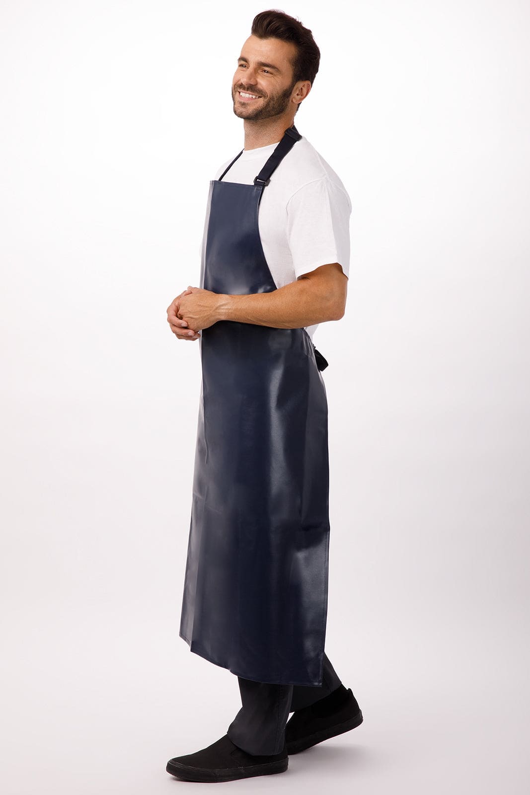 A navy Long PVC Bib Apron worn by a smiling man, featuring a logo, suitable for workwear.