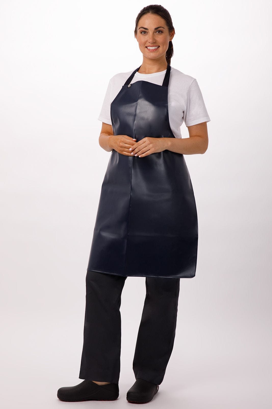 A navy PVC bib apron is worn by a woman, paired with a white t-shirt and black pants. The apron has a logo.