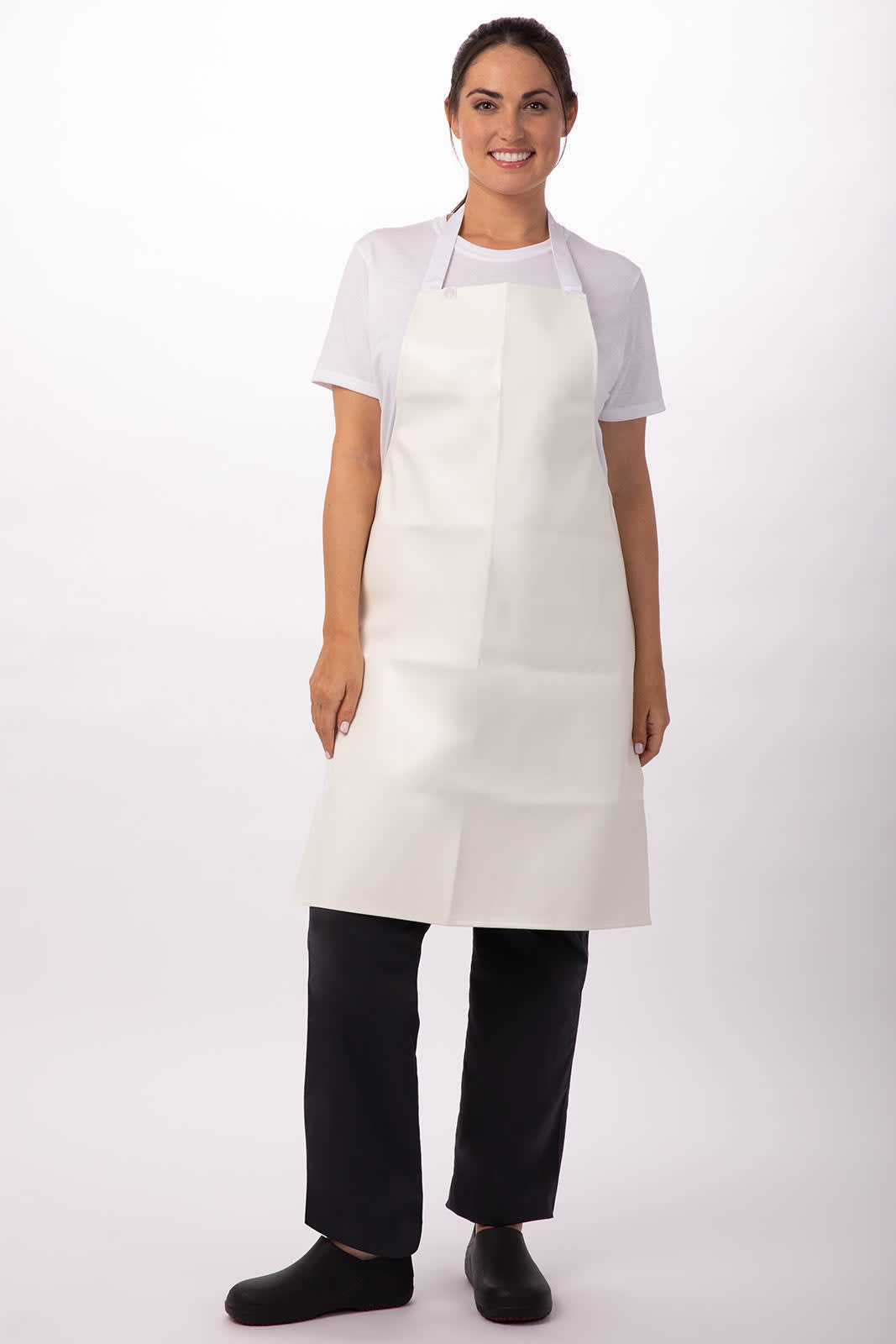 A woman wearing a white PVC bib apron over a plain t-shirt and black pants, standing against a neutral background.
