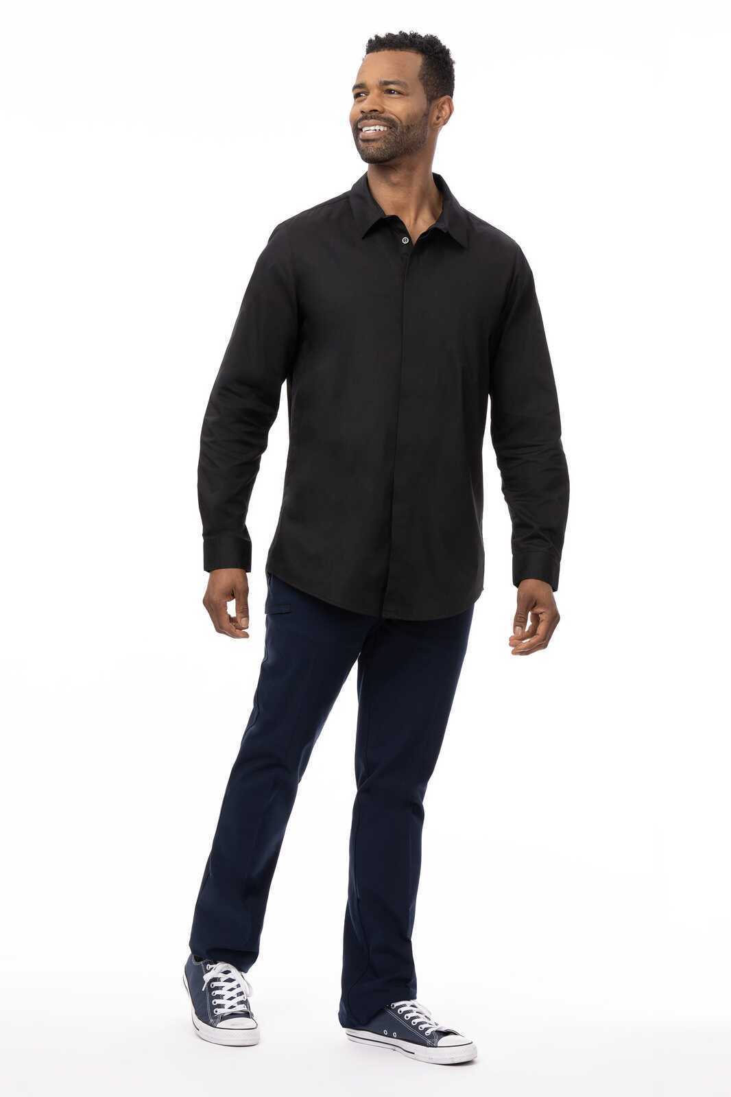 A black premium formal men's dress shirt with a collar, paired with navy pants and sneakers. The model is standing and smiling.