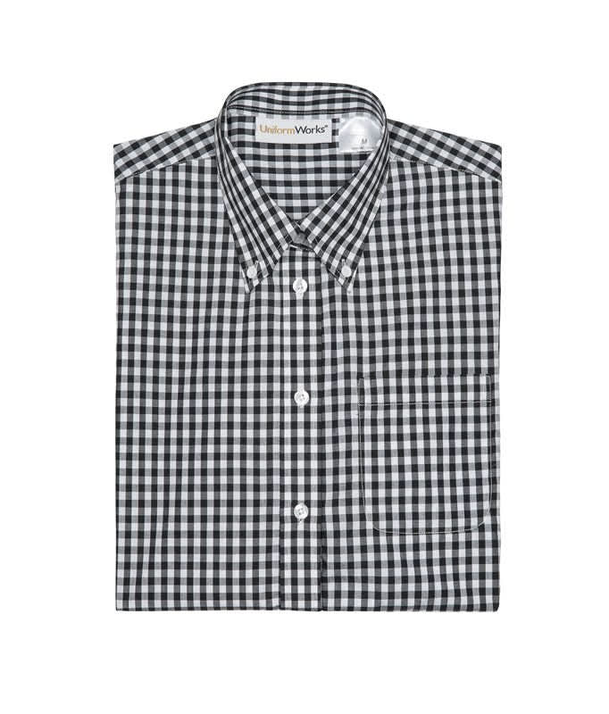 A folded black and white checked button-up shirt featuring a collar and a pocket. The shirt has a logo on the label.