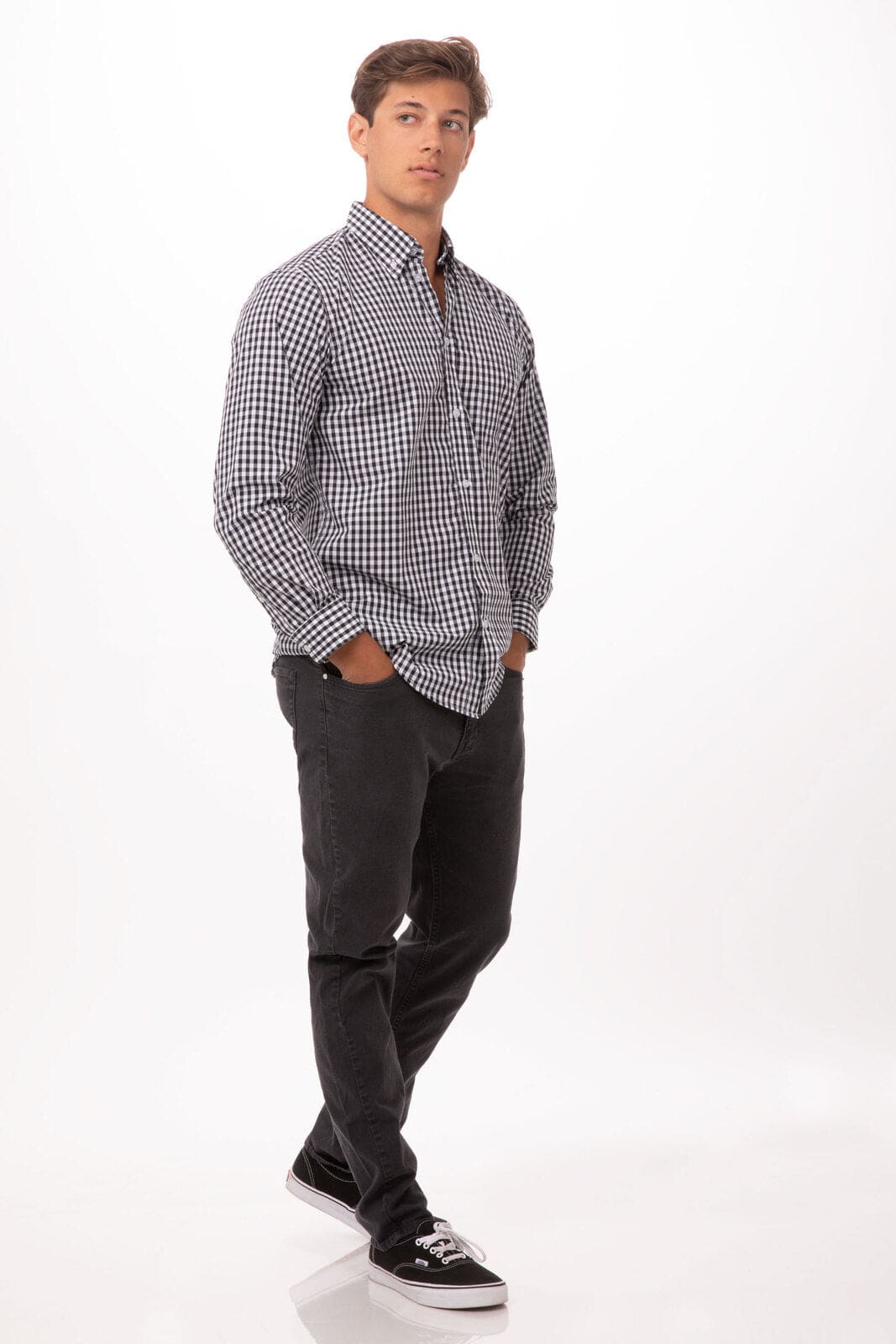 A white and navy checked button-up shirt with a logo, worn over dark trousers and sneakers.