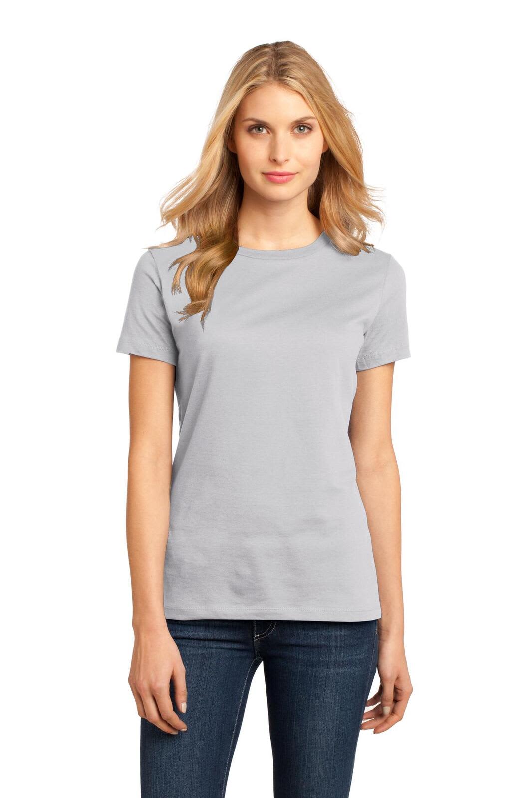 A woman is wearing a light grey crew neck t-shirt paired with jeans. The shirt features a subtle branding logo.