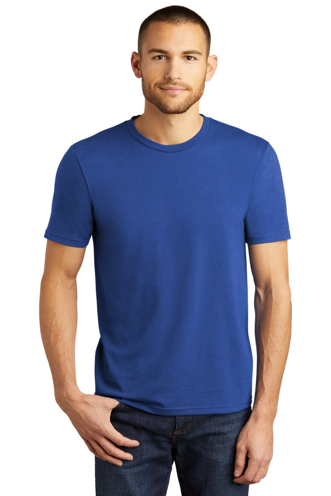 A blue crew neck t-shirt is worn by a man standing against a plain background, featuring a logo.