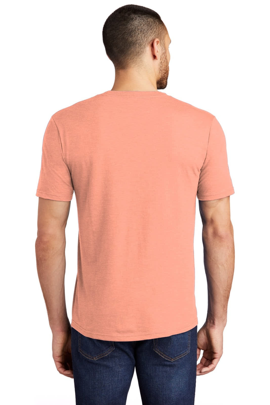 A man wearing a back view of a peach-coloured t-shirt, paired with blue jeans. The t-shirt features a logo.