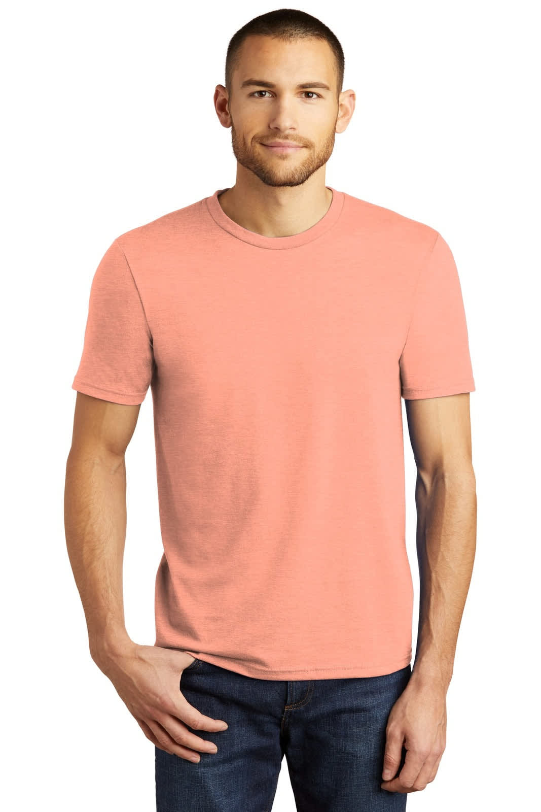 A man wearing a coral T-shirt poses for the camera, showcasing a simple crew neck design. The shirt has a logo on it.