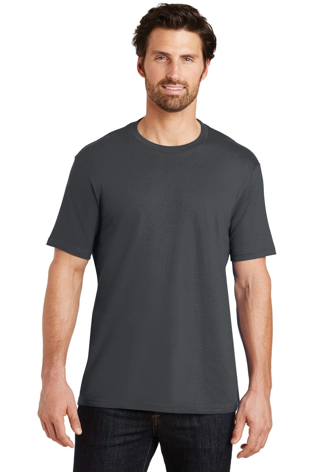 A man wearing a dark grey crew tee, standing against a neutral background. The shirt features a logo.