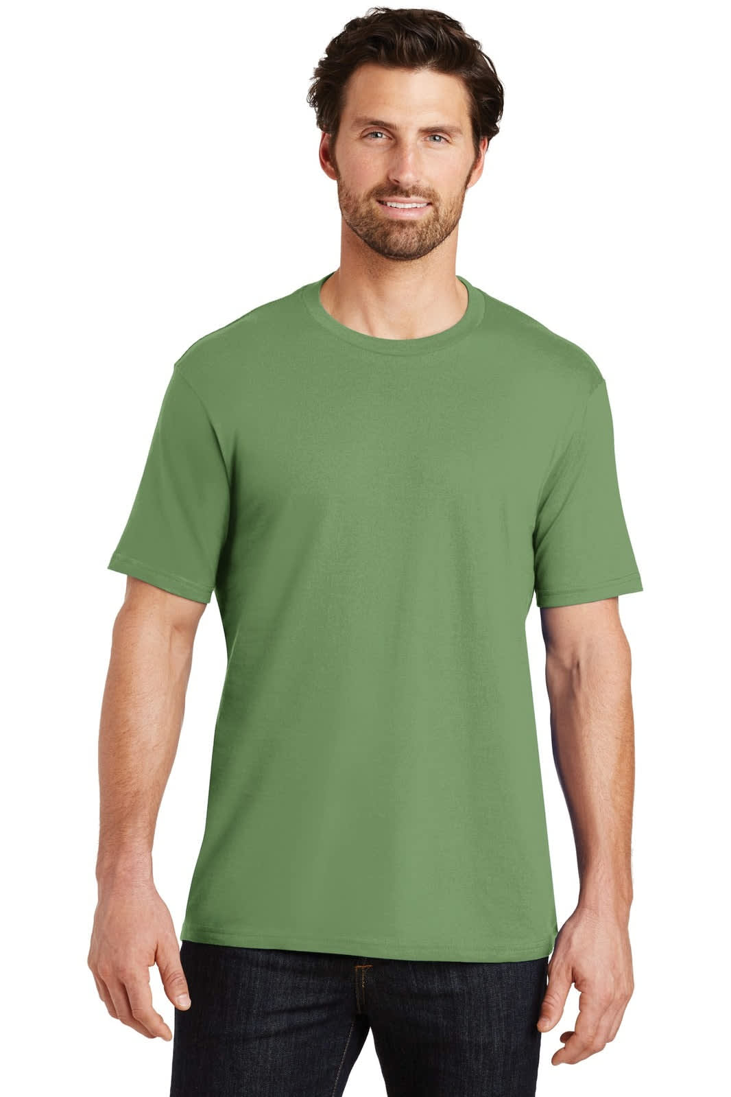 A man stands wearing a green crew neck t-shirt in a casual pose. The shirt has a logo on it.
