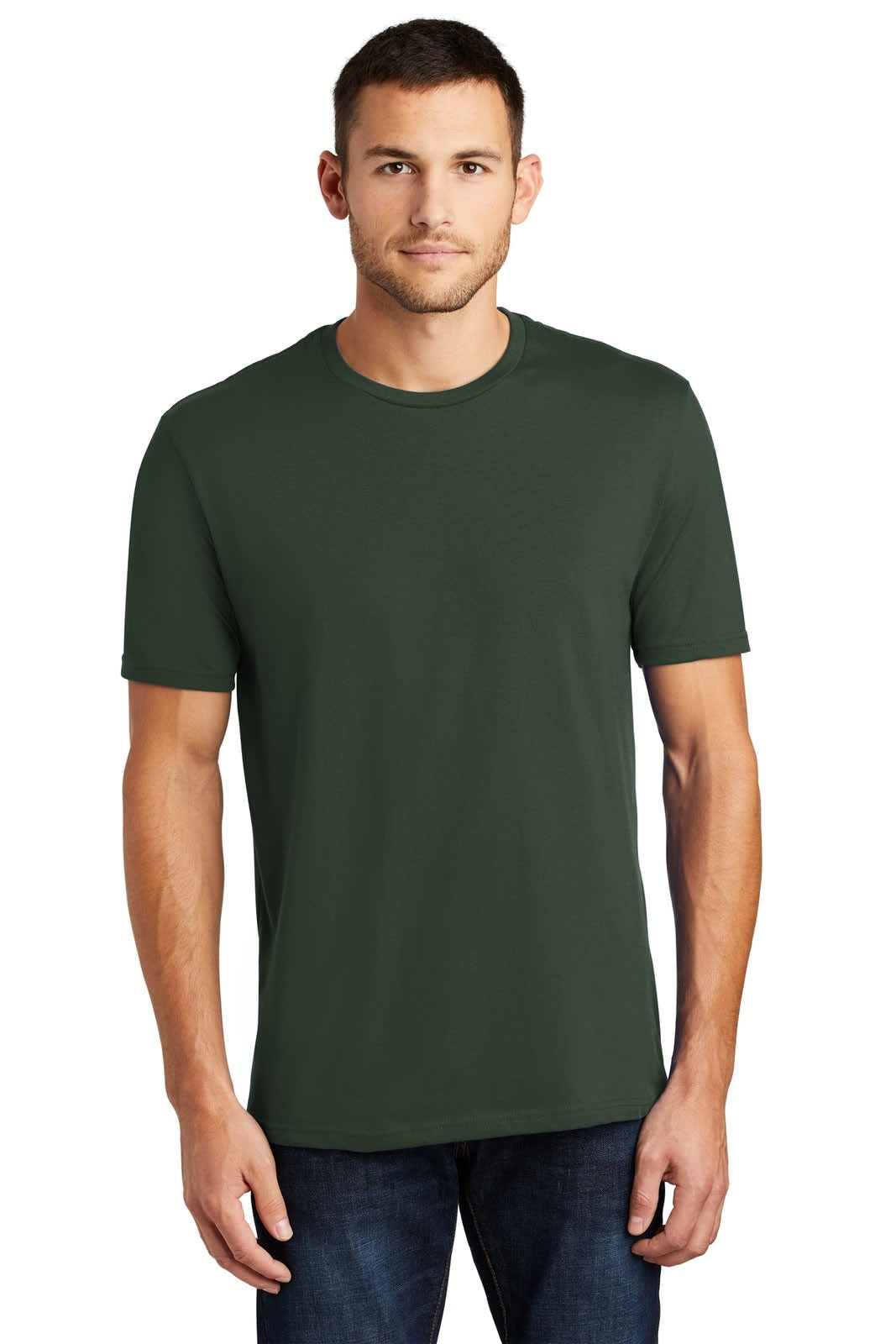 A man wearing a dark green crew neck t-shirt, paired with blue jeans, standing against a neutral background.